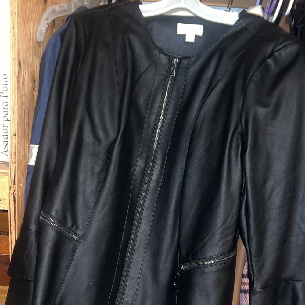 Black leather jacket with ruffle sleeves . Belle by Kim Gravel